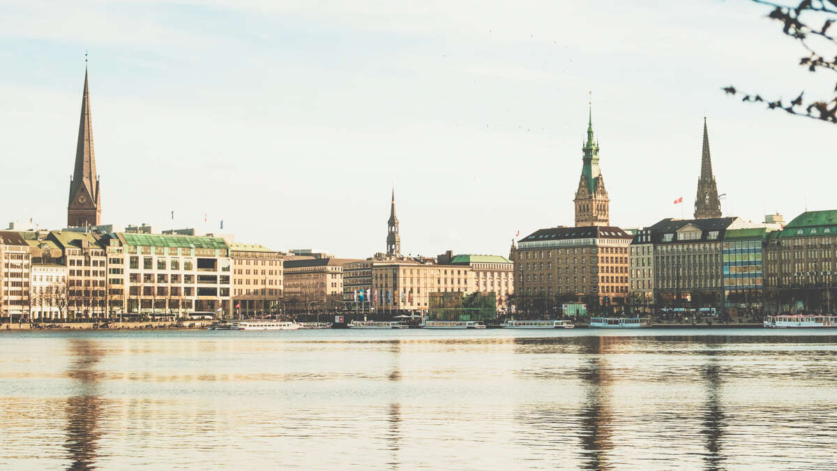 view of hamburg city from alster lake with reflections of the city in the surface of the water